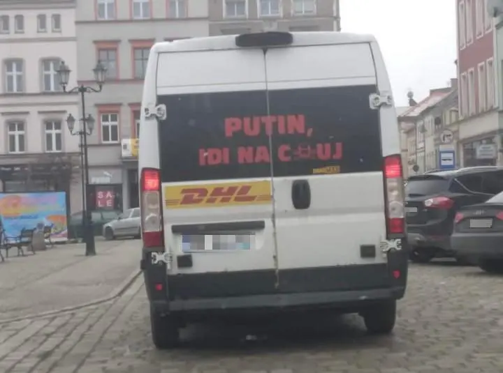 A DHL delivery van with Putin go fuck yourself in russian written on it&rsquo;s back window
